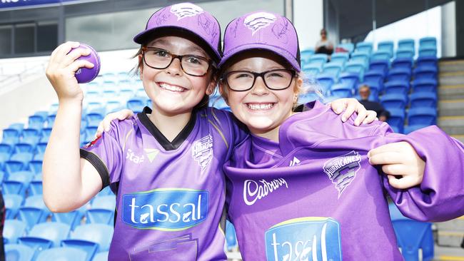 Sisters Georgia, 9, and Bethany Scharvi, 7, of Rowes Bay watch the Hobart Hurricanes’ open training session at Blundstone Arena. Picture: ZAK SIMMONDS