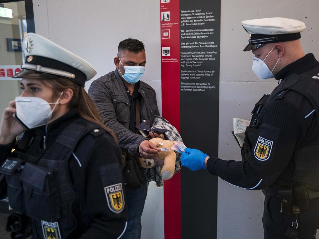 A border police officer checks a passport of a passenger arriving on a flight from Spain at Frankfurt Airport during the second wave of the coronavirus pandemic on January 28, 2021. Picture: Thomas Lohnes/Getty Images