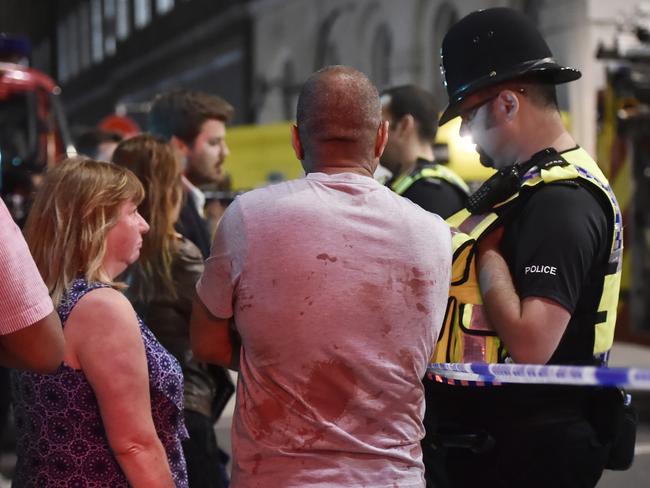 Jag Sandue speaks with police officers after an incident near London Bridge. Picture: Reuters