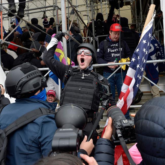 A man calls on people to raid the building as Trump supporters clash with police. Picture: Joseph Prezioso/AFP