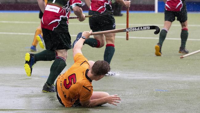 Easts Nick Budd hits the deck after the big wet passed over the State Hockey Centre. Picture: Renae Droop