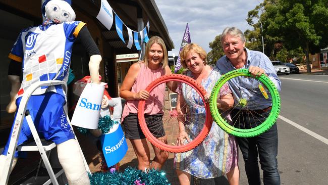 Anni Rhodes, Jenni Mitton and Sandy Mount on Main Rd, McLaren Vale, getting in a festive mood ahead of last January’s Tour Down Under. Picture: AAP/Keryn Stevens.