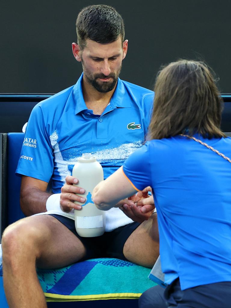 Novak being tended to by the medical team. (Photo by Cameron Spencer/Getty Images)