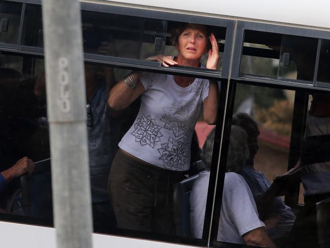 A devastated Jani Klotz watched helplessly as fire ravaged their home while she was driven away on a bus with other residents. Picture: Gary Ramage