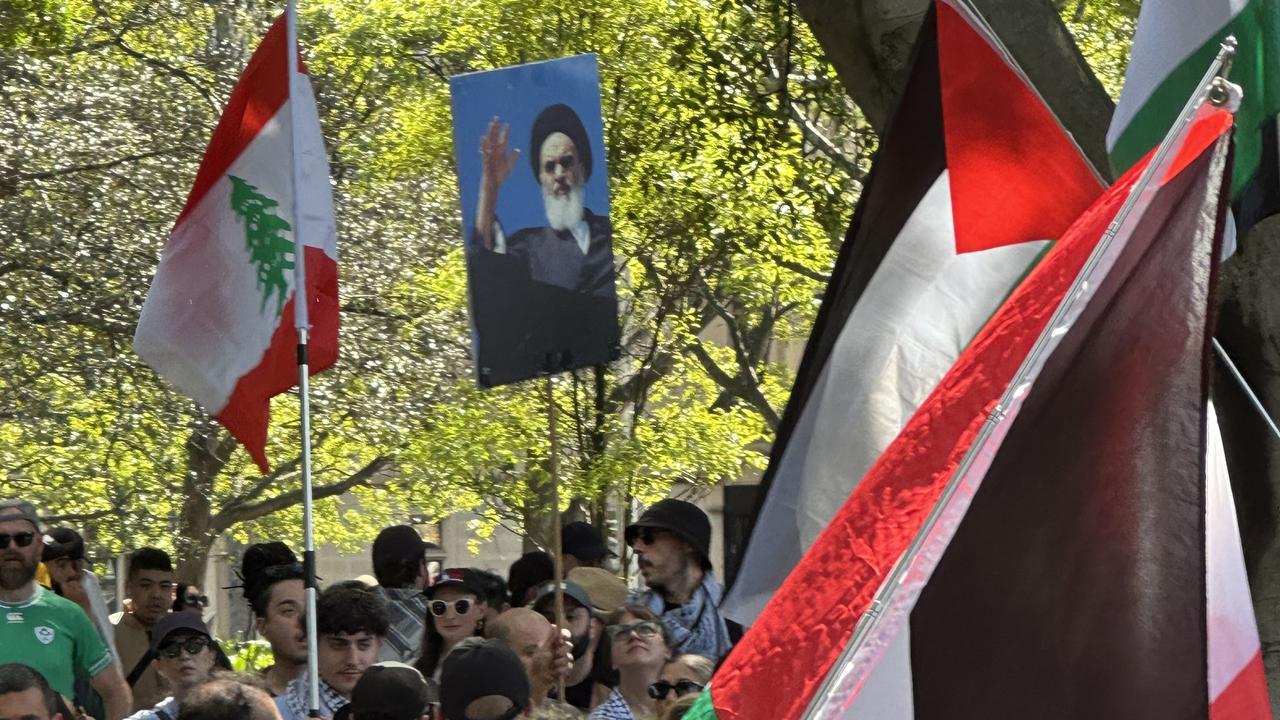 Two separate protesters were seen holding portraits of Hassan Nasrallah. Picture: Madeleine Bower