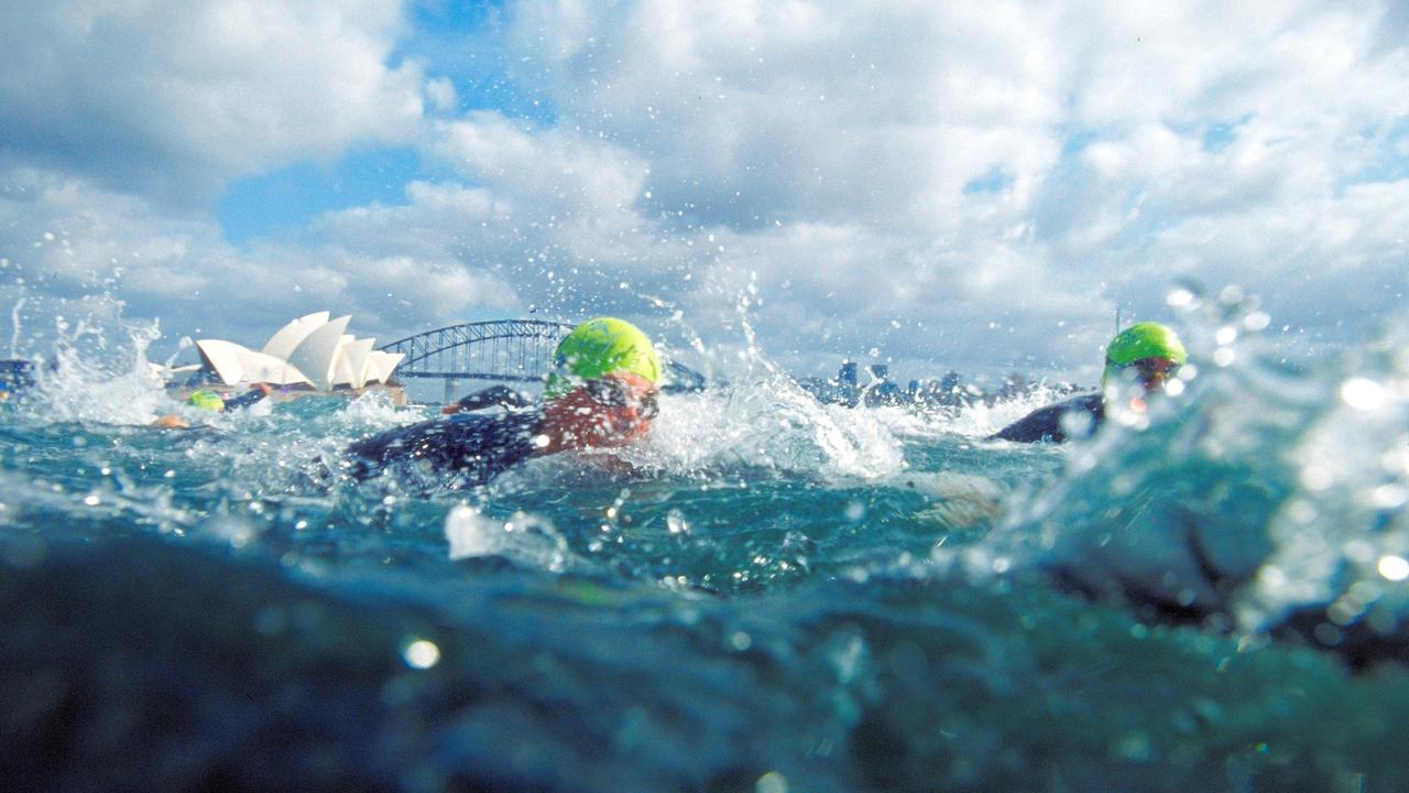25. Competitors in action in the swim section of the Women's Triathlon, with the Opera House in the background during the Sydney 2000 Olympic Games. Picture: Adam Pretty/Allsport
