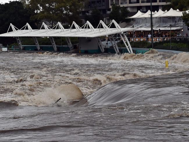 A ferry terminal is submerged by the overflowing Parramatta river. Picture: Saeed Khan/AFP Photo