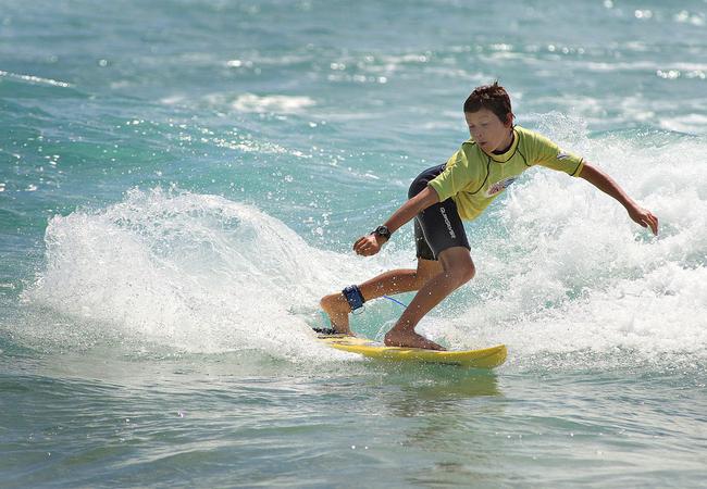 A junior competitor in the shore break. Picture: Blainey Woodham