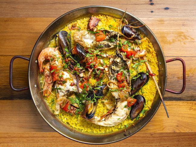 Seafood paella. Lobster, giant king prawns, mussels, octopus, chorizo in a seafood rice. Picture: AAP/Renae Droop