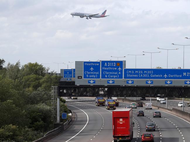 A plane takes off from Heathrow over the M25 motorway. Picture: AFP.