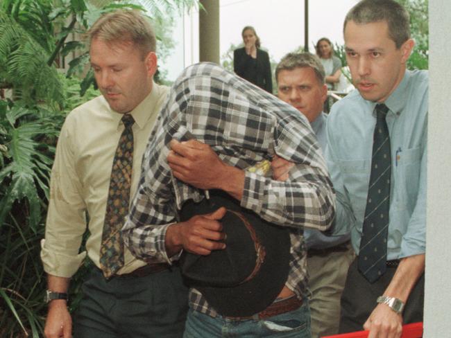 Derek Sam is led to Maroochydore watch-house by detectives after being charged with murder of missing babysitter Jessica Gaudie. Picture: Graeme Parkes.