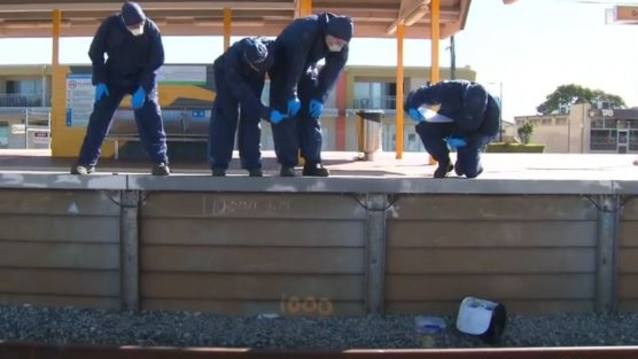 The packed lunch of a man allegedly bashed to death at a Perth train station is seen nearby the tracks as police examine the scene. Picture: Nine News