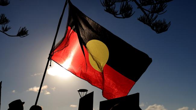 An Aboriginal flag flies over the Protest march and gathering at Byron BAy for Back Lives Matter. Photo Scott Powick Newscorp