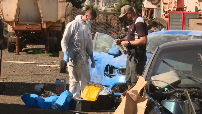 Police at the scene remove items including stolen goods and a firearm.