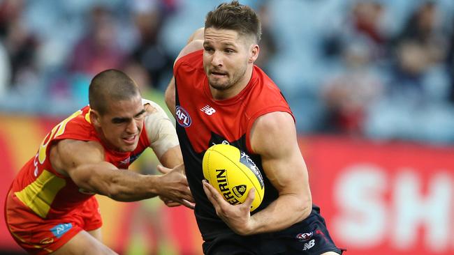 Jesse Hogan breaks the tackle of Jacob Dawson. Picture: Michael Klein