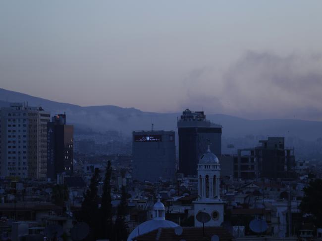 Smoke rises after air strikes targeting different parts of the Syrian capital Damascus.