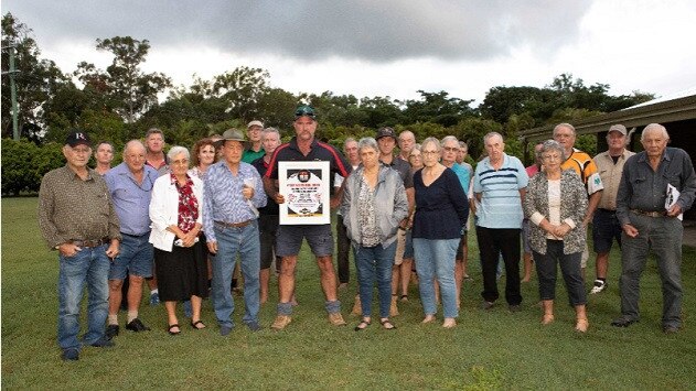 Mark Mason, centre (holding poster), with other concerned landholders and locals at therecent emergency meeting at Moorlands.