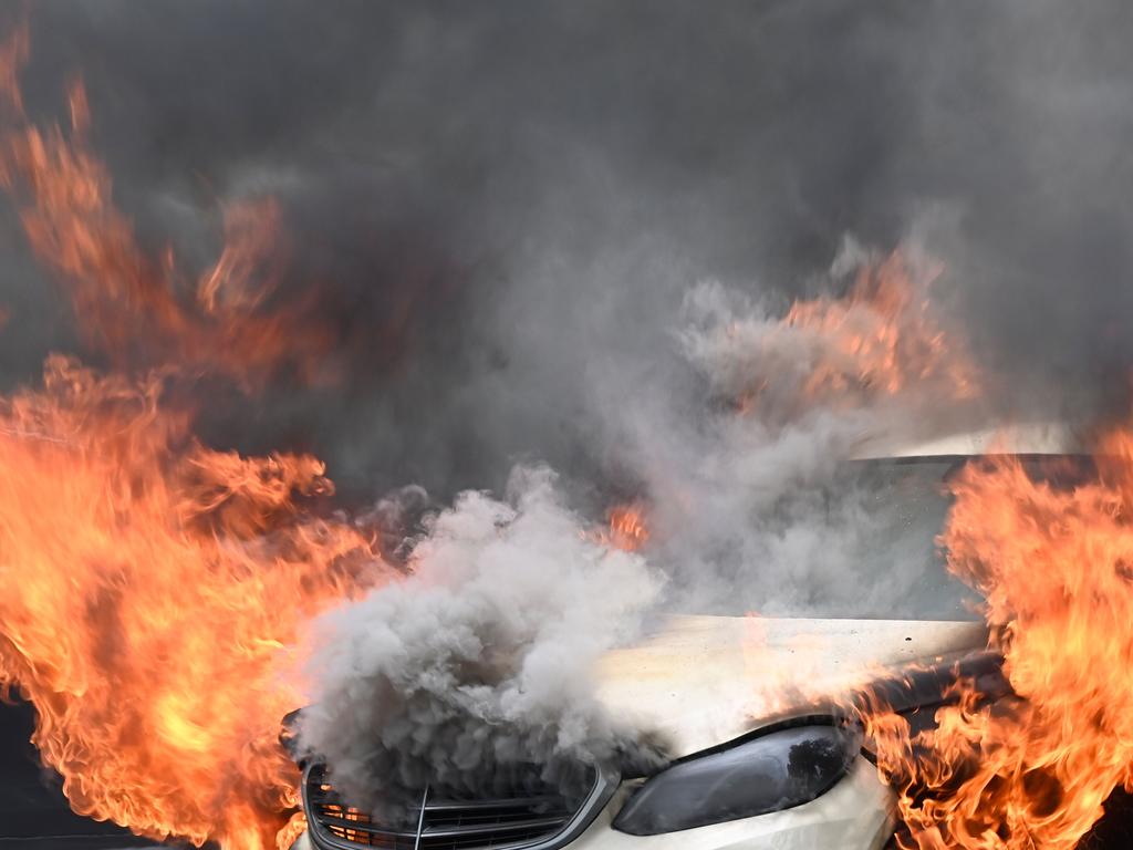 A burning car is pictured in Berlin on August 10, 2020. (Photo by Tobias SCHWARZ / AFP)