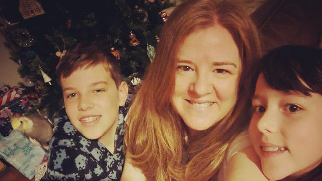 Reggie sitting on Angus's shoulder on Christmas Day, with mum Julie and sister Molly next to them. 