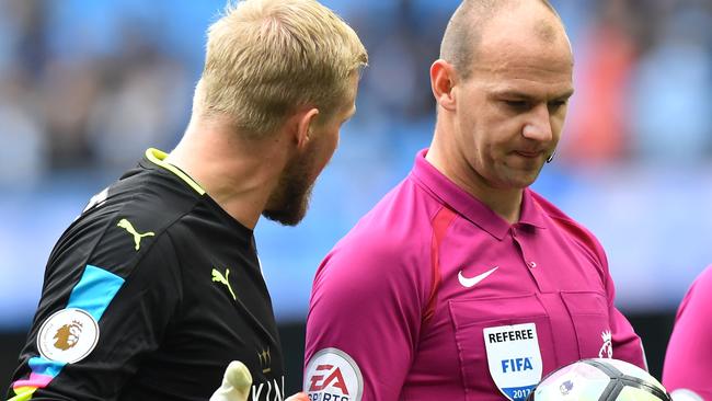 Leicester City's Danish goalkeeper Kasper Schmeichel (L) talks with referee Robert Madley.