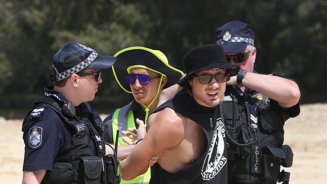 Black Swan Lake protest at Bundall goes to another level, with protesters chaining themselves to the fence and then getting themselves arrested after running onto the worksite and stopping the trucks. Protester known only as 