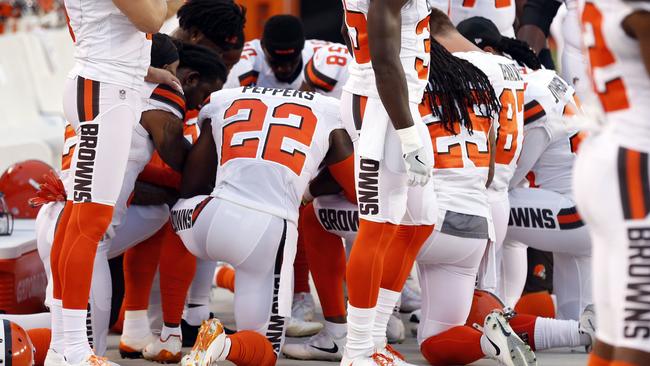 Members of the Cleveland Browns kneel during the national anthem.