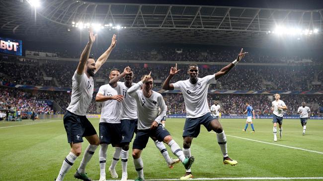 France's forward Antoine Griezmann (C) celebrates his goal