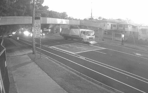 Debris goes flying after a truck hit a beam at Dutton Park's Annerley Rd bridge. Picture: Queensland Rail