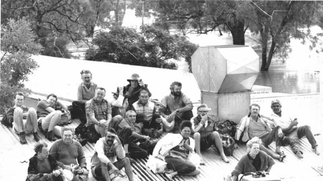 A group of people on top of the Victoria Hotel kitchen, waiting for a rescue helicopter. Charleville 1990 flood.