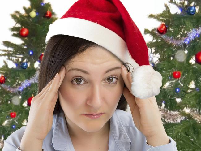 Stressed woman shopping for gifts of christmas with red santa hat looking angry and distressed