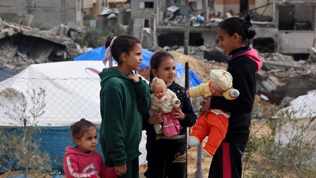 Palestinian children play in front of rubble at a makeshift camp in Rafah. Picture: AFP