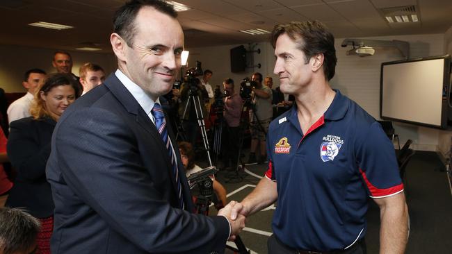 Former Bulldogs chief executive Simon Garlick shakes the hand of the Bulldogs’ new coach. Picture: David Caird