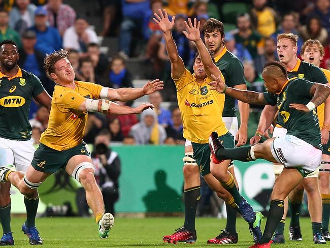 The Wallabies charge down Elton Jantjies’ late drop goal attempt.