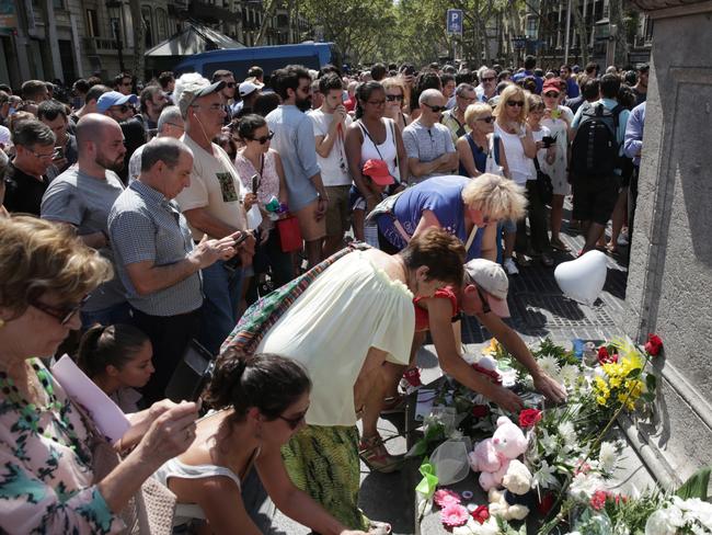 People lay flowers on Las Ramblas the day after the attack. Picture: Ella Pellegrini