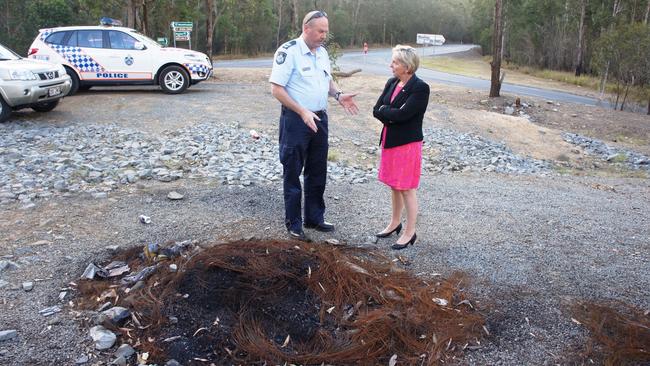 Nerang police Senior Sergeant Peter Gordon and Mudgeeraba MP Ros Bates inspect the remains of burnt out tyres at Numinbah Valley. Picture: Supplied