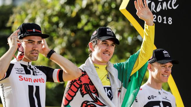 Global audience: Celebrating the 2018 Tour de France is this year’s winner, Great Britain's Geraint Thomas draped in a Welsh flag. Second-placed Netherlands' Tom Dumoulin is to his left and third-placed Great Britain's Christopher Froome to his right. Picture: AFP PHOTO/Thomas Samson