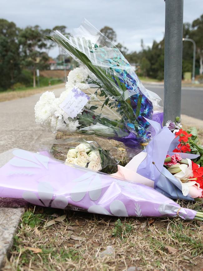 Flowers left at the scene of the alleged murder. Picture: Richard Dobson