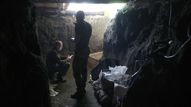 Ukrainian servicemen of the 10th Mountain Assault Brigade "Edelweiss" stand in a dugout near Bakhmut in the Donetsk region. Picture: AFP