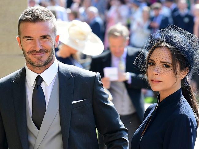 Former England footballer David Beckham (L) and fashion designer Victoria Beckham (R) arrive for the wedding ceremony of Britain's Prince Harry, Duke of Sussex and US actress Meghan Markle at St George's Chapel, Windsor Castle, in Windsor, on May 19, 2018. / AFP PHOTO / POOL / Ian West