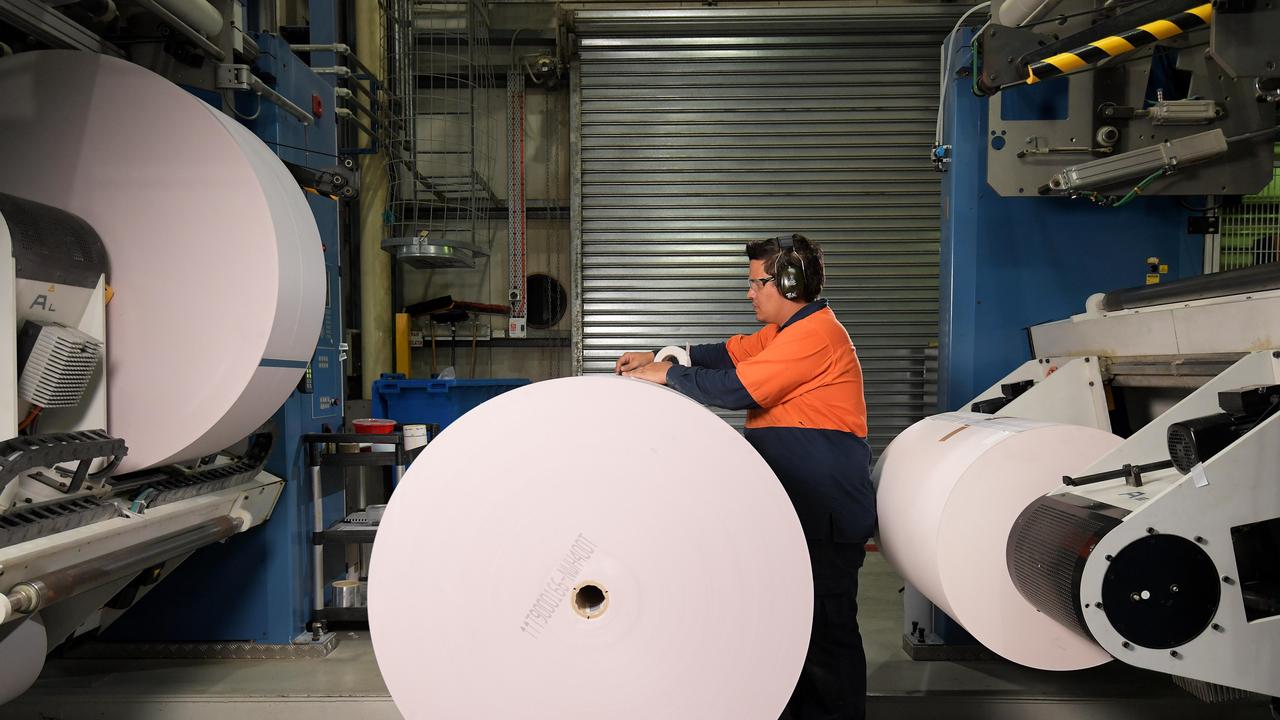 Press line leader Benjamin Ngaia removes tape from a roll of paper during the printing process. Pictures: KERI MEGELUS