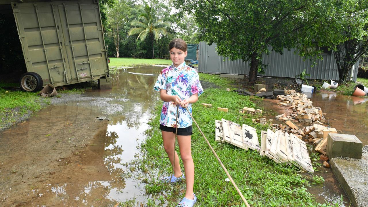 Nyah Waugh 9, stand where a container stood before her Forrestry Road home was inundated by a fast rising Bluewater Creek. Picture: Evan Morgan