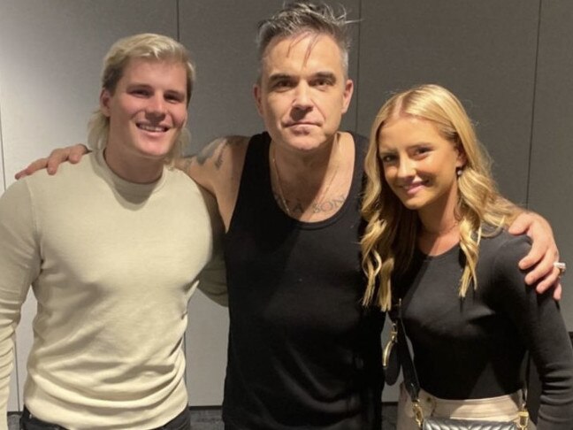 Robbie Williams with Shane Warne’s son Jackson and his girlfriend Kiah Broadsmith at Rod Laver Arena.