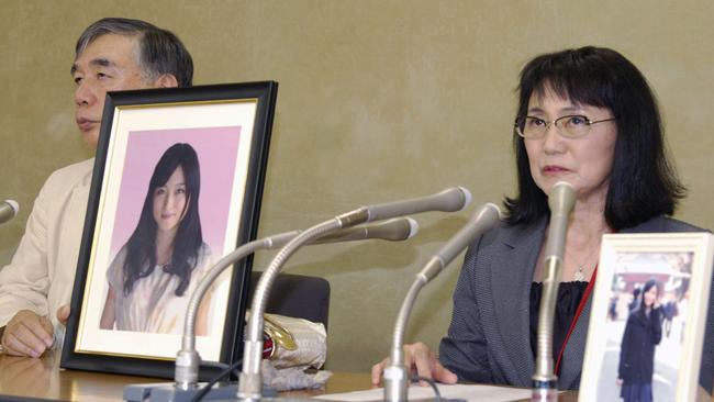 Yukimi Takahashi, right, mother of Matsuri, with lawyer Hiroshi Kawahito, speaks to journalists at a news conference in Tokyo about her daughter's suicide. Picture: Kyodo News/AP