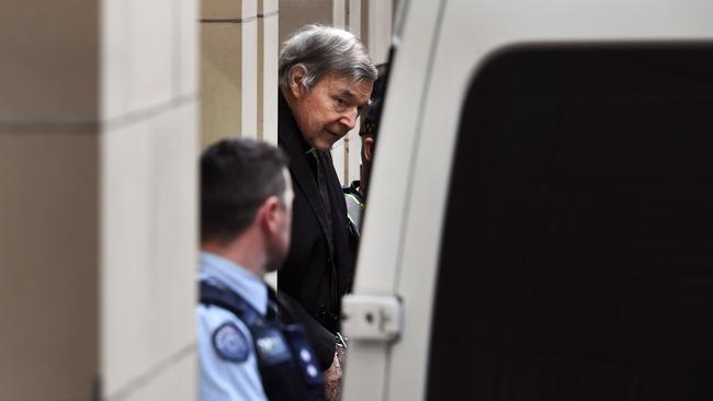 Australian Cardinal George Pell being escorted in handcuffs from the Supreme Court of Victoria in Melbourne in 2019. Photo by William West / AFP