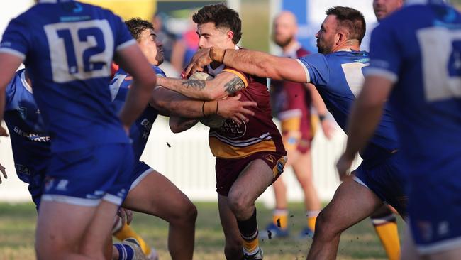 Braxton Wallace is wrapped up by the defence. Picture: Steve Montgomery/Ourfootyteam