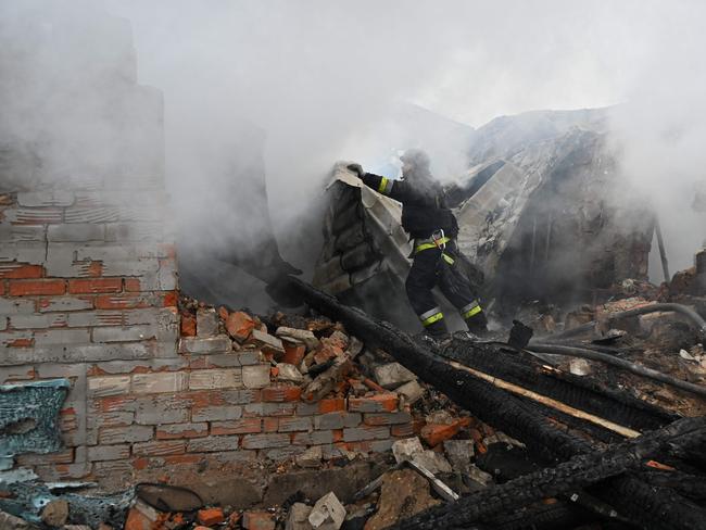 A rescuer of the State Emergency Service works to put out a fire in a private house after a drone strike in Kharkiv, on December 25, 2024. Picture: AFP