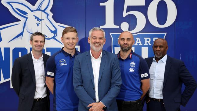 Brady Rawlings (left), captain Jack Zeibell, North Melbourne chairman, Ben Buckley, coach Rhyce Shaw and CEO, Ben Amarfio pose during a North Melbourne Picture: ROBERT CIANFLONE/GETTY IMAGES