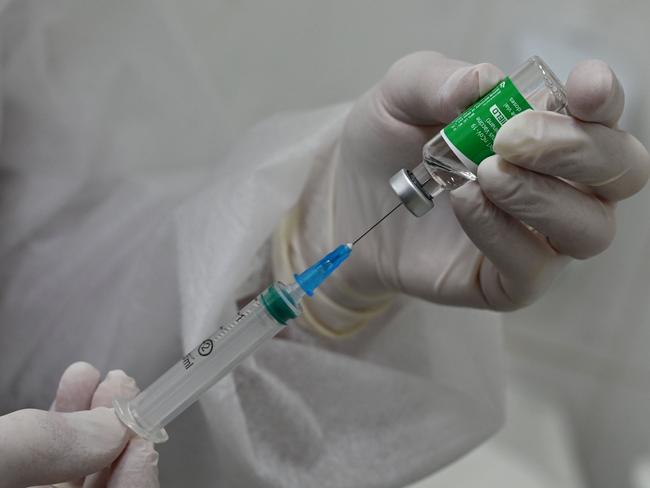 A medical worker draws up a dose of the Oxford/AstraZeneca vaccine against the coronavirus disease, marketed under the name Covishield and produced in India, in a syringe during the vaccination of people in an outpatient clinic in Kiev on April 7, 2021. - Ukraine on April 7, 2021, registered another record number of coronavirus deaths and hospitalisations, with officials warning the situation is "critical". The government on April 7 reported 481 deaths in the previous day and 5,587 people taken to hospital, both the highest figures recorded since the start of the pandemic. (Photo by Genya SAVILOV / AFP)