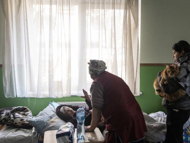 An elderly women says goodbye to Volentini, a volunteer at the elderly hospice before being evacuated from Irpin. Picture: Getty Images