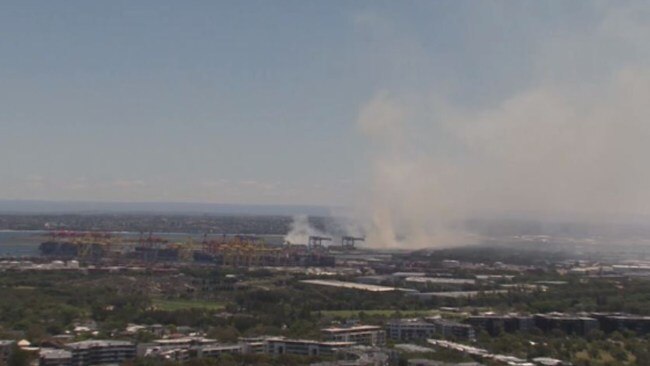 The grass fire ignited next to the third runway at Sydney Airport. Picture: Nine